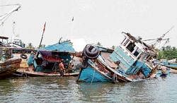 Trawlers damaged due to heavy rain and strong winds that lashed Thota Bengre in Mangalore district, on  Sunday. DH Photo