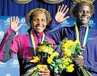 Bosbundle of joy:  Boston Marathon winners Teyba Erkesso (left) and Robert Kiprono Cheruiyot wave happily for shutterbugs on Monday. AP