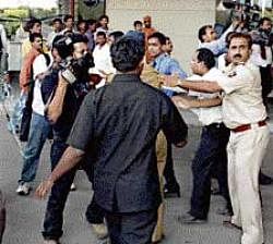 Bouncers and security personnel push back mediapersons during the arrival of IPL Commissioner Lalit Modi at the airport in Mumbai on Tuesday. PTI