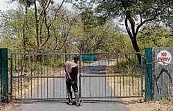 A forest official closes the gates of the lion safari area at the Sanjay Gandhi National Park in Mumbai on Wednesday. AFP