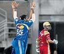 CRUSHED: Mumbai Indians players celebrate the wicket of Royal Challengers Bangalore's Rahul Dravid during the first IPL-3 semifinal match at the D Y Patil Sports Stadium in Navi Mumbai on Wednesday. PTI