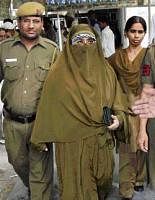 Farida Dar, the lone woman convict in the 1996 Lajpat Nagar blast case, walks free out of the court, in New Delhi on Thursday. pti