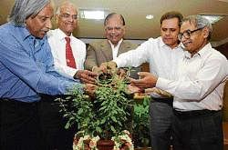 (From left) Prof at St Johns Medical College T Venkatesh, Dharwad Agricultural University former V-C  M Mahadevappa, KSPCB Chairman A S Sadashivaiah, Secretary to Department of Environment and Ecology Kanwar Pal and environmentalist Nagesh Hegde are watering a sapling at the World Earth Day programme in Bangalore on Thursday. DH Photo