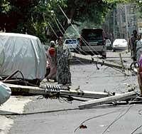 The electric poles brought down by heavy rains and gusting winds on Wednesday, in Basaveswaranagar. DH photo