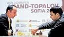 World chess champion Viswanathan Anand (right) of India makes a move against Grandmaster Veselin Topalov of Bulgaria on Saturday. Reuters