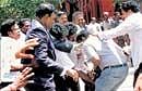 Lawyers trying to break a camera belonging to a private TV channel during their protest against Tamil Nadu Chief Minister M Karunanidhi in Chennai on Sunday. PTI