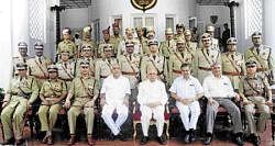 Governor H R Bhardwaj, Chief Minister B S Yeddyurappa and Home Minister V S Acharya with police officers after the Police Investiture Ceremony in Bangalore on Monday. dh photo