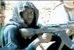 A video grab shows accused bomber Umar Farouk Abdulmutallab and others fire weapons at a desert camp in Yemen. AP