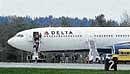People walk out of Delta Air Lines Flight from Paris to Atlanta which was diverted to Bangor International Airport. AP