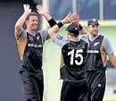 NZs Ian Butler (left) celebrates with team-mates after dismissing irelands John Moony on Tuesday. AP