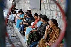 testing times for them too: Parents waiting outside the CET exam centre at Baldwin Methodist College in Bangalore on Wednesday. dh Photo