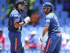 Indian captain MS Dhoni (R) and Yuvraj Singh during the match against Afghanistan on Saturday. AFP