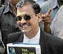 Special Public prosecutor Ujjwal Nikam smiles as he holds his report following the verdict outside the special court set up for the trial of  Ajmal Kasab on Monday. AP