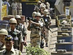 Armed security officers patrol outside the special court set up for the trial of 26/ 11 accused Mohammed Ajmal Kasab, in Mumbai on Monday. AP