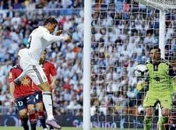 golden header Cristiano Ronaldo rises above the Osasuna defence to nod home the  match-winner in Real Madrids 3-2 victory on Sunday. afp
