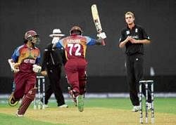 West Indies batsman Andre Fletcher (centre) celebrates after scoring the winning run along with batting partner Shivnarine Chanderpaul on Monday. AP