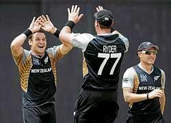well done, mate:  Nathan McCullum (left) and Jesse Ryder celebrate the wicket of Zimbabwes Craig Ervine during their World Twenty20 match on Tuesday. afp