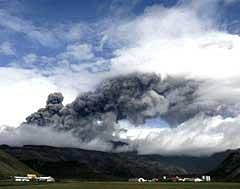 The Noepakot and Thorvaldseyri farms are dwarfed by a plume of ash rising from a volcano erupting under the Eyjafjallajokull glacier, as seen from Hvolsvollur, Iceland, on Wednesday. AP Photo