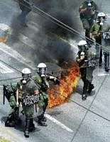 Street ire: A petrol bomb expodes near riot police during a rally in Athens on Wednesday. AP