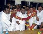 Victor V Prakash (fourth from left) being congratulated by supporters after he was declared elected unopposed for the third term for Kolar CMC. Balaji Chennaiah, V K Rajesh, K M Madhusudan Kumar, legislator R Varthur Prakash and Routh Shankarappa are seen.  DH photo