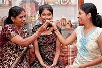State second rank holder and District topper in Science stream Vinuta Rao celebrating her  success with her mother Vidya V Rao and Sister Vinaya V Rao in Udupi on Friday. DH Photo
