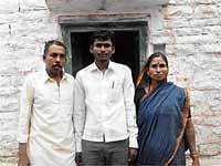Making Them Proud: SKPU College student Basayya Math of Bilebhavi village in Muddebihal taluk, who scored 93.83 per cent marks in PUC Arts, is seen with his parents. DH Photo