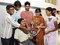 Jubilant: PUC students T R  Manjunath (Science 578), K S Suprith (Commerce 581), A L Parashuram (Commerce 587), L  Archana (Commerce 587), K  S  Sanjana (Commerce 581) and K J Sunjana (sitting  on a wheel chair)  celebrating  their success in  Bangalore on Friday. DH Photot