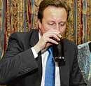 Tory Leader David Cameron drinks a pint of beer in Witney, Oxfordshire, on Friday. AFP