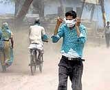 Swirling danger: People brave a dust storm in Mathura,  Uttar Pradesh, on Friday. PTI