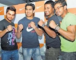 ALL SMILES:  From left: Indian cricketers Virat Kohli, Pragyan Ojha and S Sreesanth alongwith    boxer Vijender Singh (second from left) pose during a promotional event on Saturday. DH photo