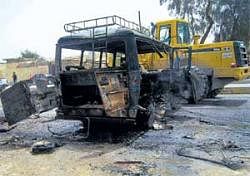 Trail of destruction: The site of a bus explosion in Iskandiriyah, 50 km south of Baghdad, on Monday. AFP