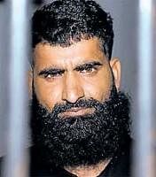 Civil engineer Faiz  Mohammad stands behind bars at a police station in Karachi on Monday. AFP