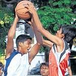 TOUGH BATTLE: Rangers Naidu (left) and YCBCs Vishwas vie for the ball in the State youth basketball meet. DH PHOTO