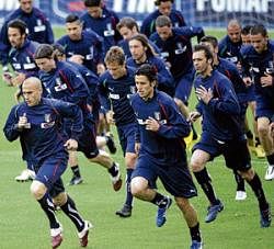 Blue wave: Italian players limbering up ahead of a training session. AFP