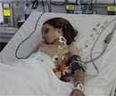 Dutch boy 9 Year-old Ruben van Assouw is seen in his hospital bed in Tripoli's El Khadra hospital in Libya on Thursday. AP