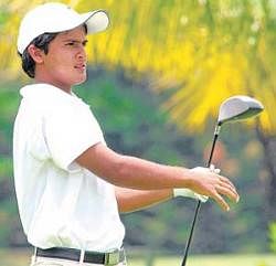 Striking a pose: Ashbeer Saini follows the progress of the ball during his second-round 68 in the Asia Pacific Junior Golf Championship at the Eagleton Golf Resort on Friday. DH photo