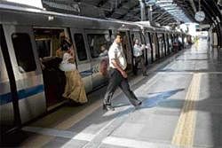 Changing face of public transport: Commuters take the New Delhi Metro at a station. NYT