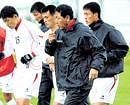 North Korean coach Kim Jong-Hun (right) and his wards train at the  Saint Jacques stadium in the Swiss Alpine village of Ayent on Friday. AP
