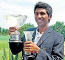 Bangalore teenager S Chikkarangappa shows off his spoils after  clinching his maiden international title at the Eagleton Golf Resort on Sunday. DH Photo