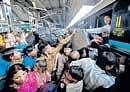 Passengers scramble to enter the Patna-bound 2393 Up Sampark Kranti Express train at the New Delhi Railway Station on Sunday. AFP