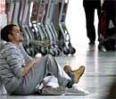 ssengers relax after flights were cancelled due to the volcanic ash cloud, at Newcastle International Airport, England, Sunday. AP