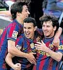 Barcelonas Lionel Messi (right), Pedro  (centre) and Bojan Krkic celebrate after their team  retained the La Liga title on Sunday. Reuters