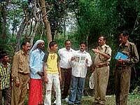 RFO M S Chinnappa giving information to volunteers on identifying blocks before beginning elephant census in Anekadu reserve forest near Kushalnagar. Forester K P Somanna, volunteers B C Muruli Madaiah and H K Thilagar are seen. dh photo