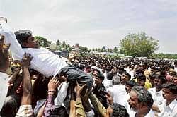 the winner takes it all: Supporters lift a winning candidate outside a counting centre at Kengeri in Bangalore on Monday. dh Photo
