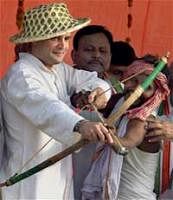 AICC General Secretary Rahul Gandhi checks a bow and arrow presented to him by a tribal supporter during a rally in Uttar Pradesh on Tuesday. PTI Photo