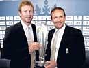 England skipper Paul Collingwood (left) and coach Andy Flower hold the World T20 trophy upon arrival in London on Tuesday. AP