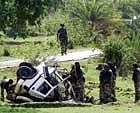 Deadly strike: Police and paramilitary soldiers inspect the mangled remains of a vehicle after it was blown up by suspected Maoist rebels in the Chowkishal forest of West Midnapore district in West Bengal on Wednesday. AP