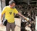 A Greenpeace scientist takes radiation measurements at the Mayapuri scrap market in New Delhi on Wednesday. PTI