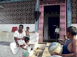 riches to rags: Hanumanthappa with his grandchildren at his house in Shaliganur in Koppal district. He has to leave this big house once construction of new houses, meant for flood victims, is complete. dh Photo