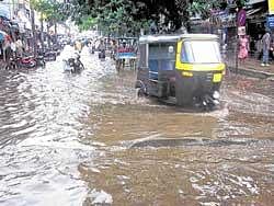 Deluge: A road which was inundated due to heavy rains in Mandya on Wednesday. dh photo